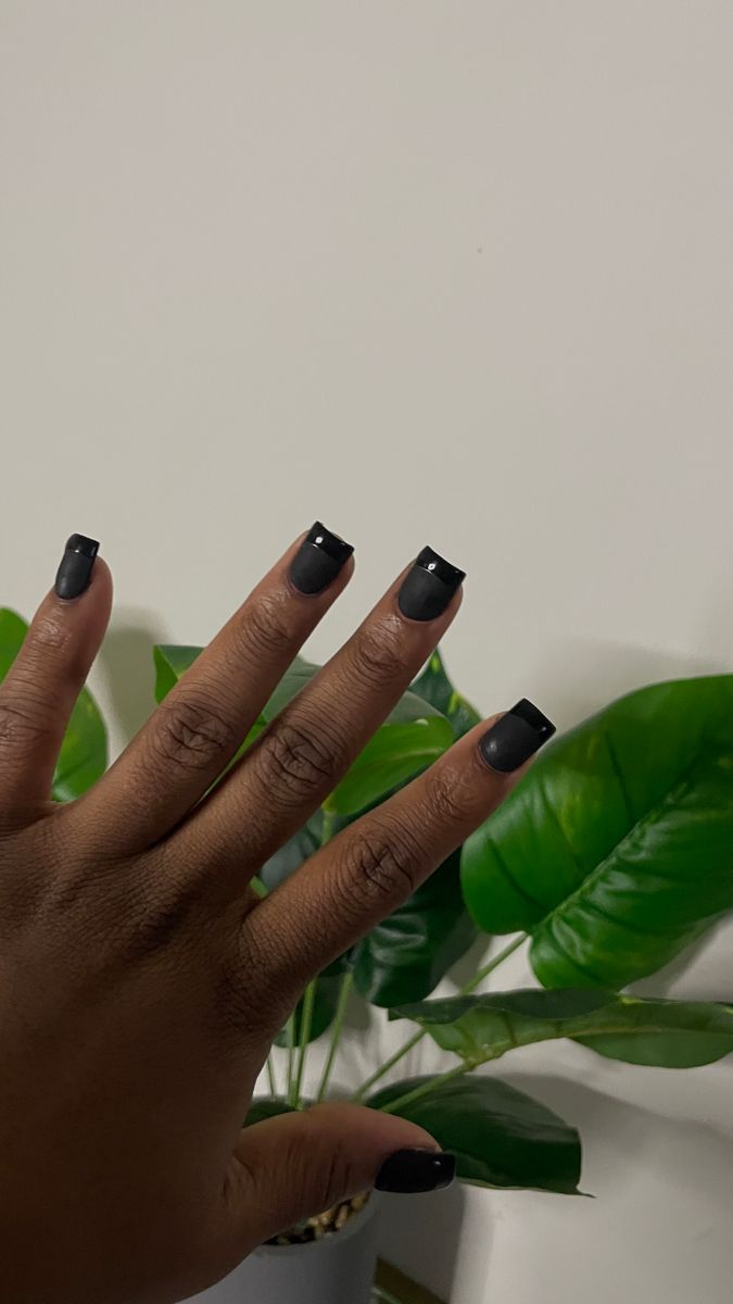 Elegant Black Matte Nails with Subtle Rhinestone Embellishments for Any Occasion.