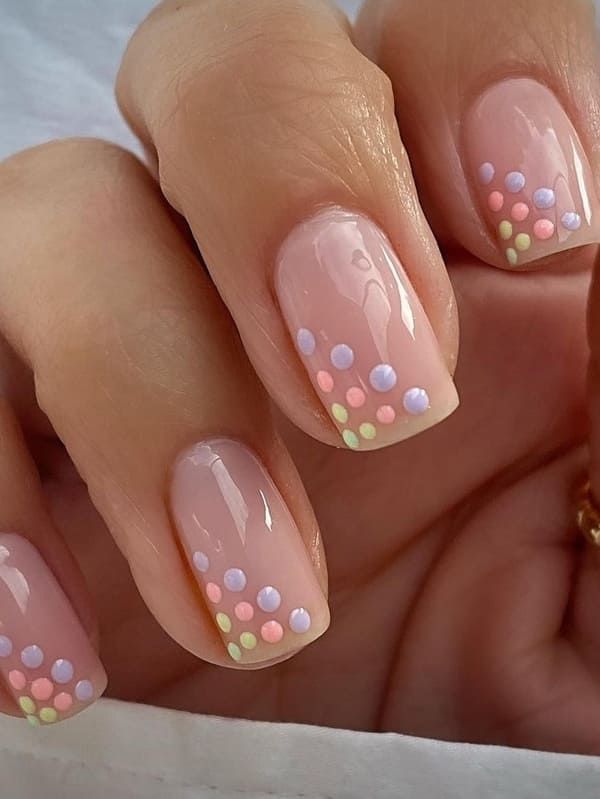 Chic Soft Nude Nail Design with Whimsical Pastel Polka Dots