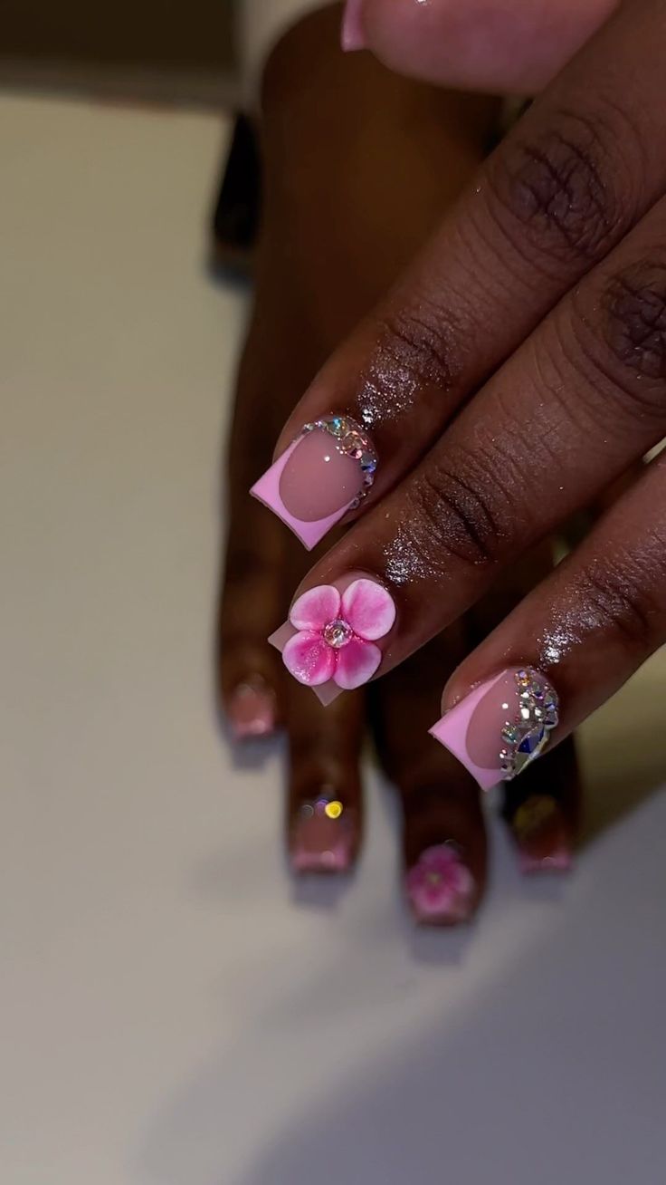 Charming Floral Nail Design with Pink Accents and Elegant Detailing.