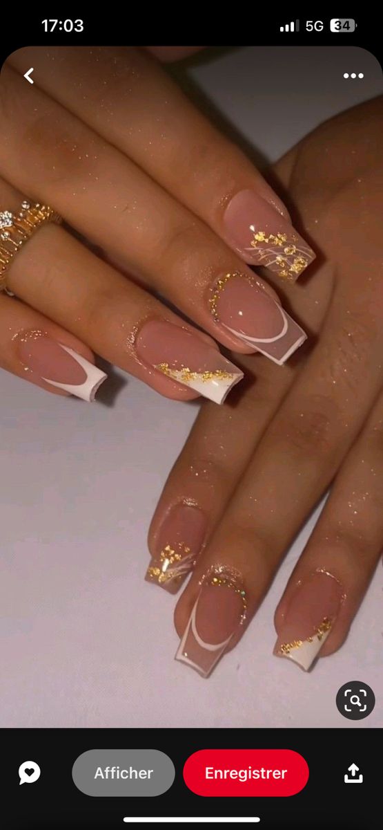 Sophisticated Nail Design: Soft Nude and French Tips with Glamorous Gold Accents.