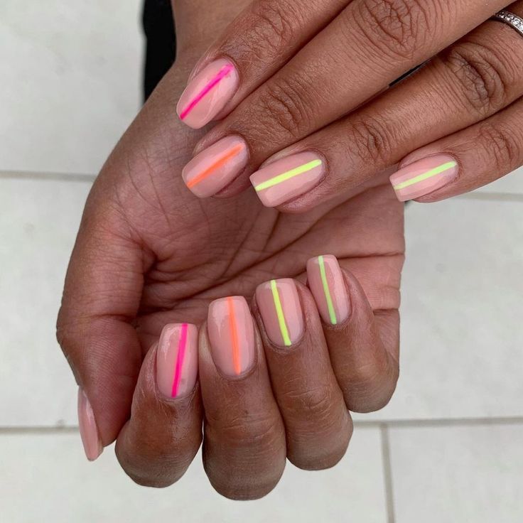 Vibrant Geometric Neon Stripes Over Nude Base for a Modern Manicure.