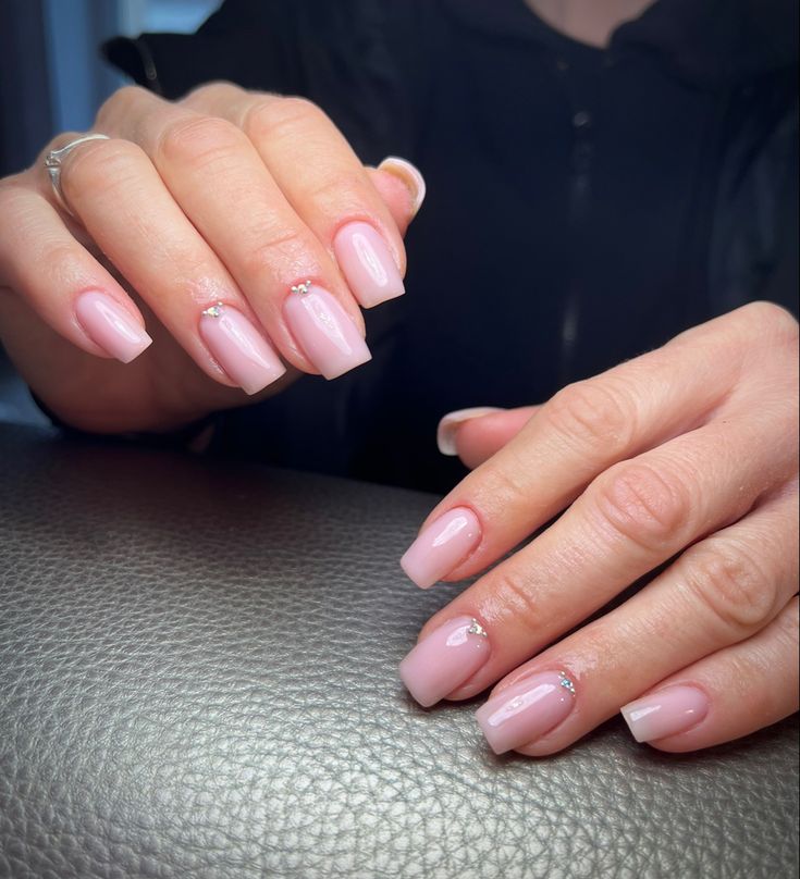 Chic Elegant Pink Nail Design with Subtle Bling and Modern Accents.