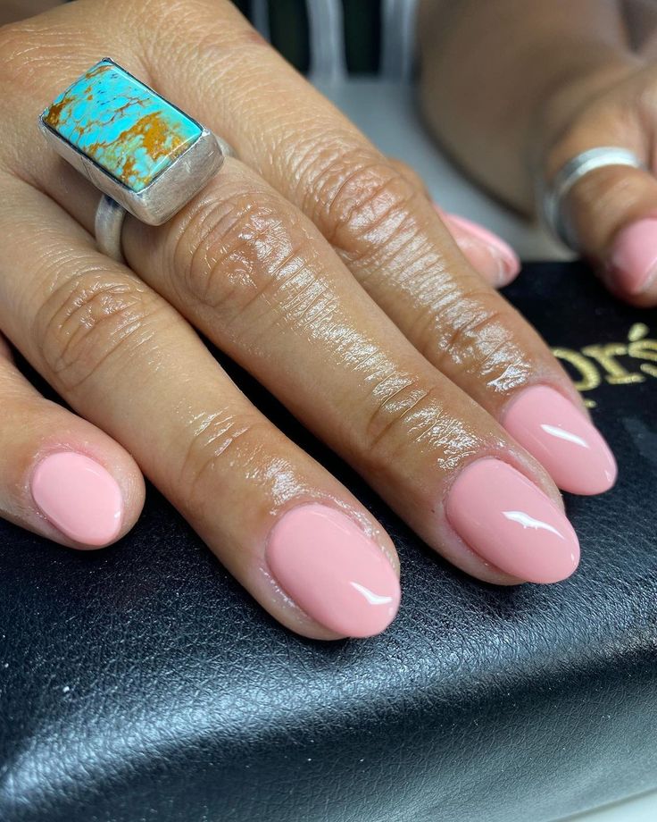 Elegant Pink Nails with Turquoise Statement Ring: A Perfect Blend of Softness and Flair.