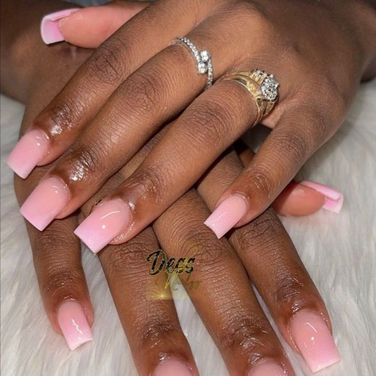 Chic Blush Pink Acrylic Nails with Square Tips and Delicate Rings for a Minimalist Look.