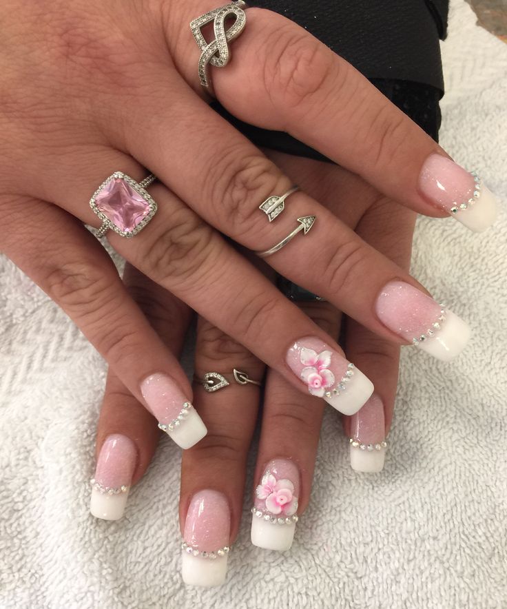 Elegant French Manicure with Floral Accents and Pearls for a Charming Look.