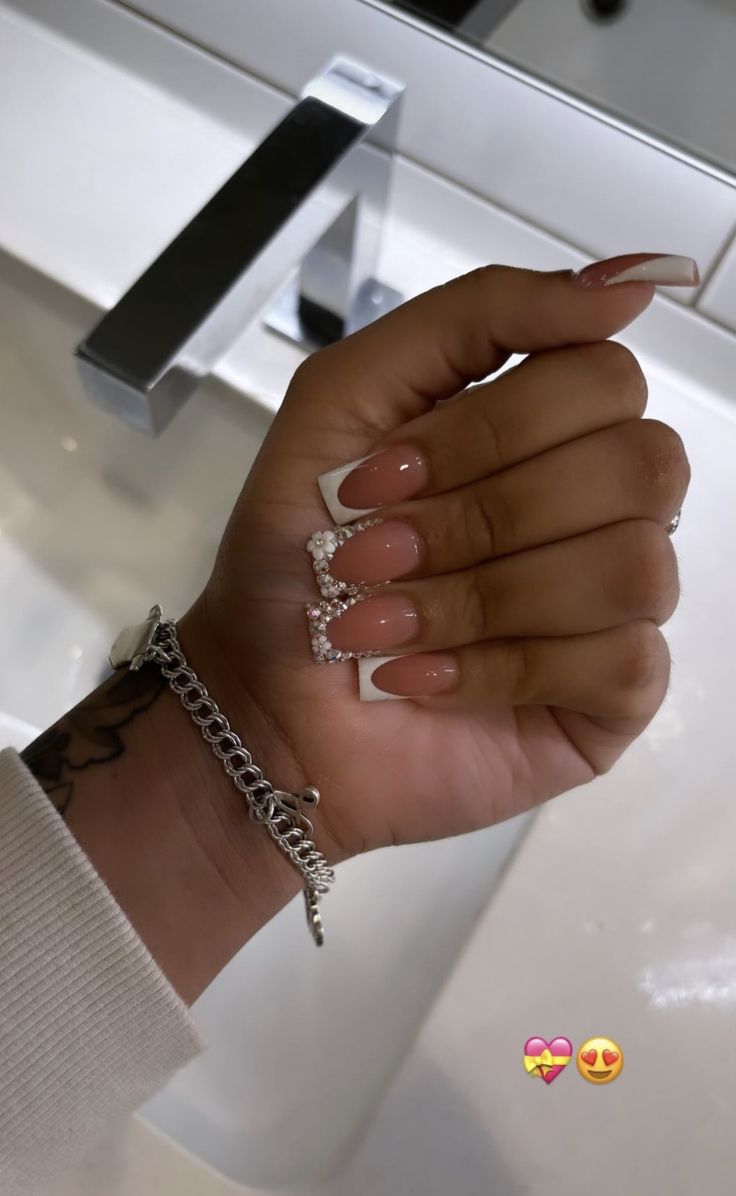 Classic French Manicure: Elegant Nude Base with Glamorous White Tips and Dazzling Rhinestones.