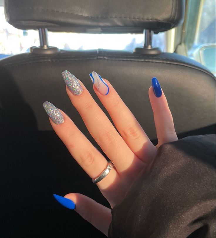 Sophisticated Elegant Nail Design: Shimmering Silver and Bold Blue with Unique Accent Pattern.