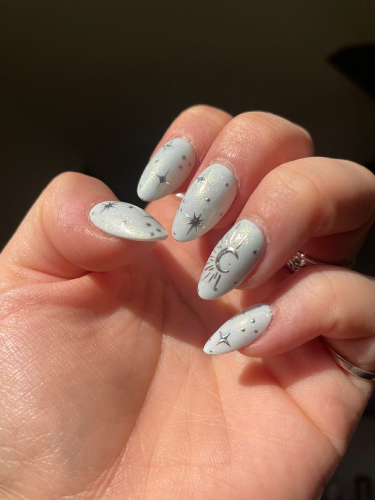 Ethereal Celestial Nail Design: Soft Gray Base with Gold and Silver Star and Moon Accents