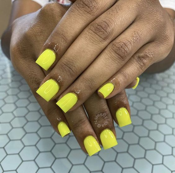 Vibrant Bold Neon Yellow Nails: A Glossy Statement in Playful Nail Art.