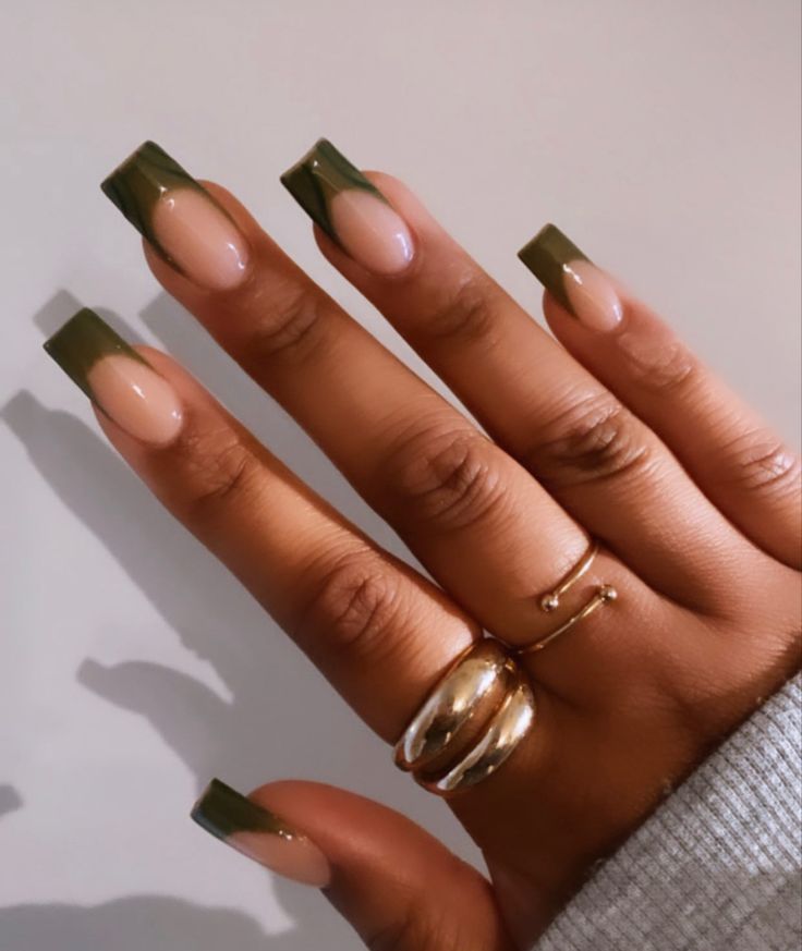 Trendy Nude and Green Nail Design with Bold Tips and Sophisticated Gold Accents.