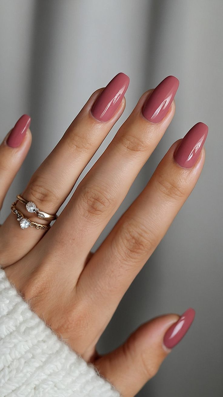 Sophisticated Mauve Almond Nails with Glossy Finish and Complementary Rings.