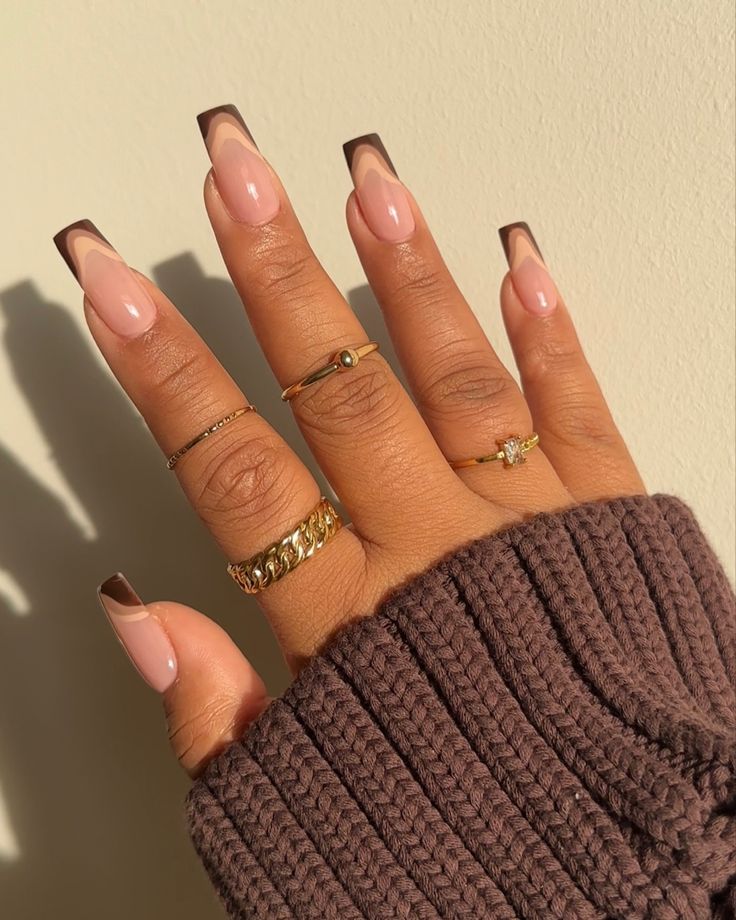 Sophisticated Autumn-Inspired Nail Design in Nude and Brown, Paired with Chic Gold Rings.