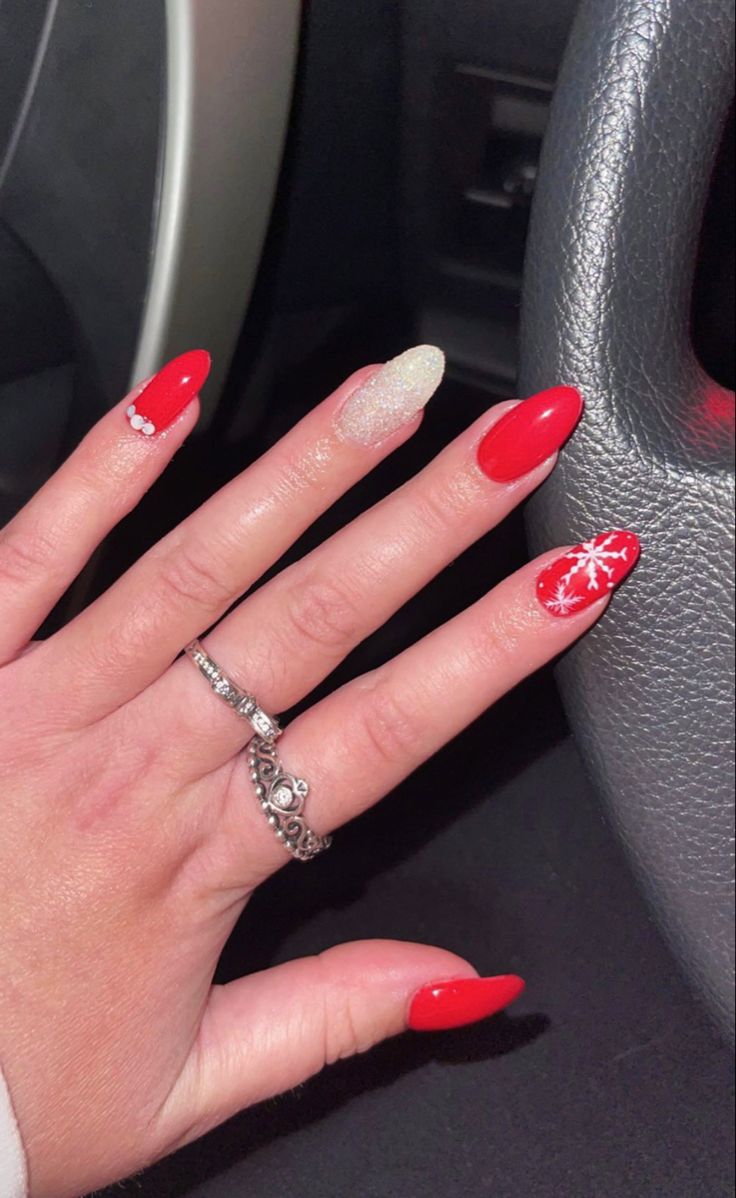 Festive Red Nail Design: Sparkling Accents and Snowflake Details for the Holiday Season.