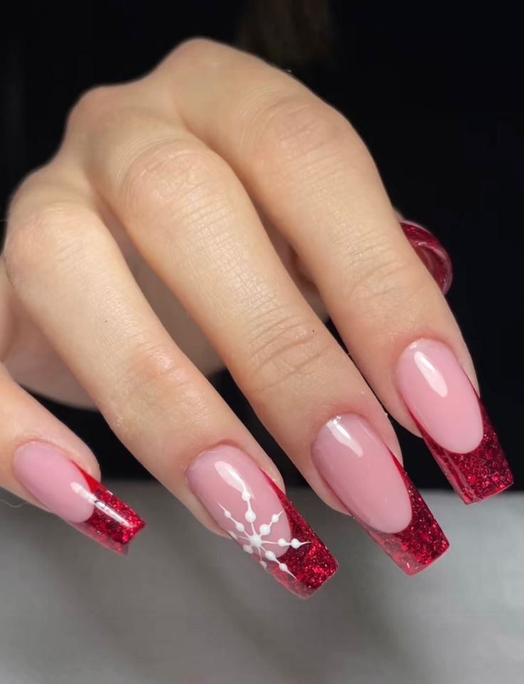 Elegant Sparkling Red and Soft Pink Nail Design with Glitter Tips and Floral Accents