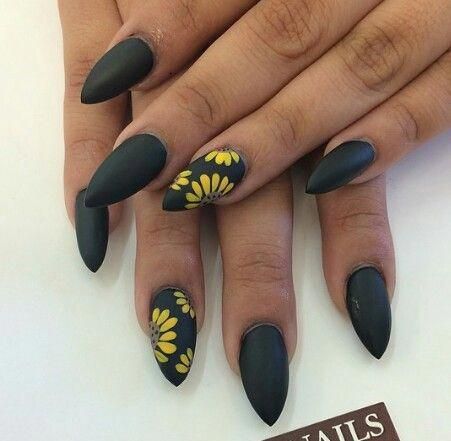 Chic Black Matte Almond Nails with Vibrant Yellow Floral Accents.