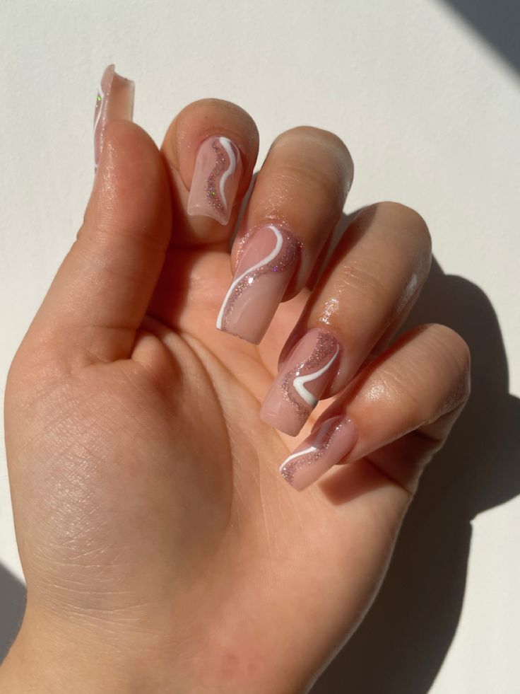 Sophisticated Nude Nail Design with Delicate White Accents and Playful Swirls