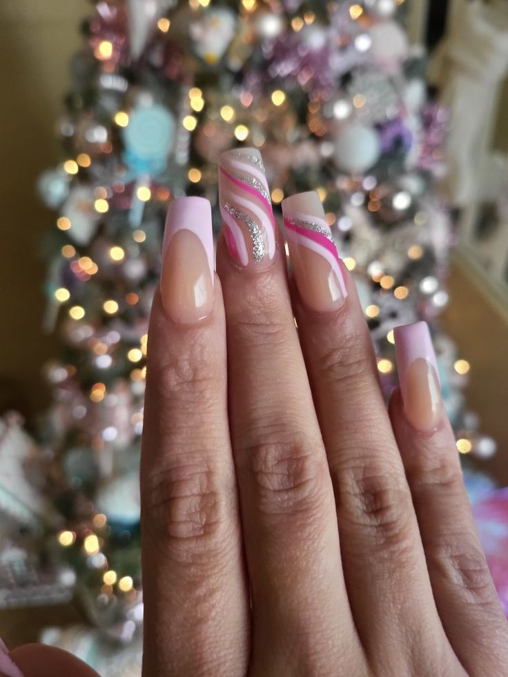 Chic Soft Pink and White Nail Design with Glamorous Silver and Pink Swirls.