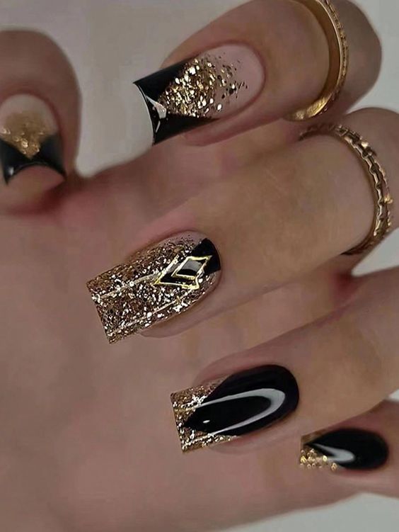 Luxurious Black and Gold Nail Design with Glitter and Geometric Elegance.