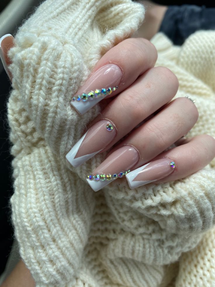 Elegant French Tip Nails with Glamorous Rhinestones: A Perfect Blend for Every Occasion.