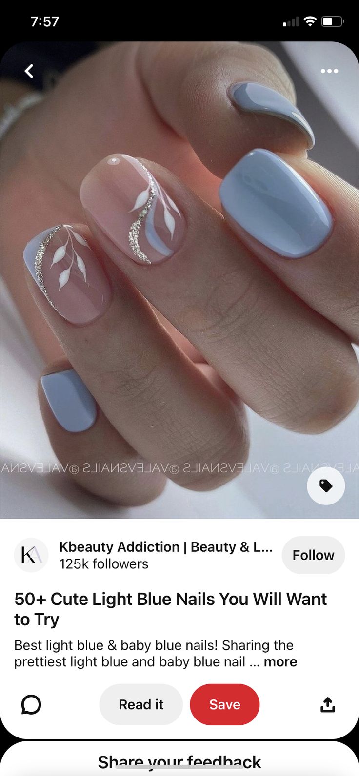 Chic Sophisticated Nail Design: Glossy Light Blue with Delicate White Leaf Patterns and Silver Accents.