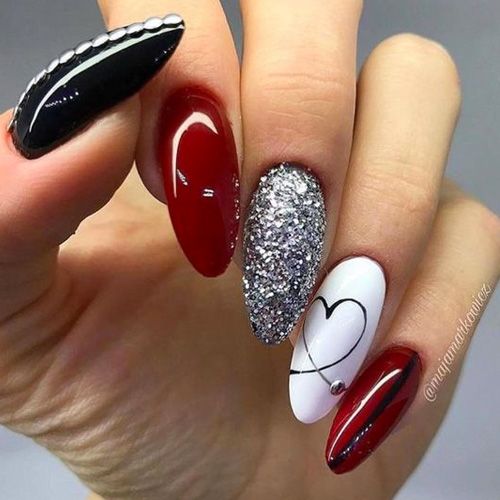 Elegant Nail Design with Red, Black, White, and Glamorous Silver Accents.