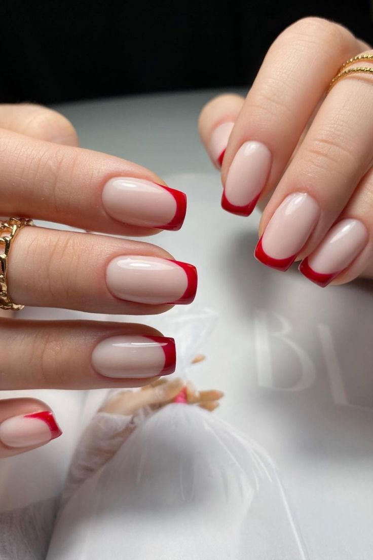 Elegant Red-Tipped Manicure: A Modern Twist on Classic French Tips