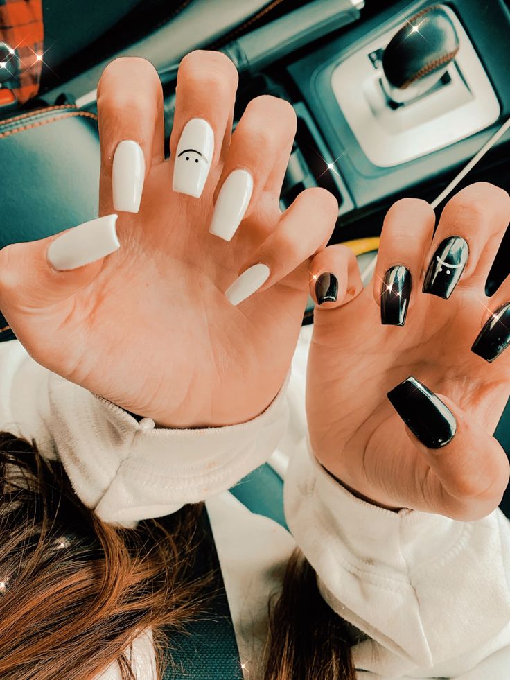 Chic Black and White Nail Design with Artistic Accents and Bold Contrasts.