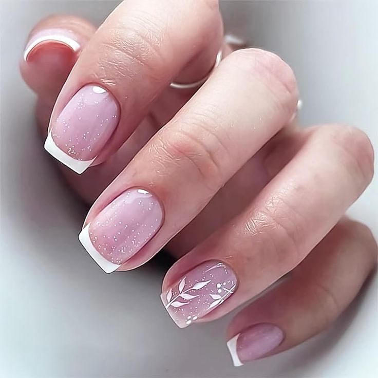 Chic Soft Pink Manicure with Glitter, French Tips, and Floral Accents