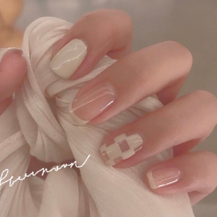 Sophisticated Nail Design with Soft Neutrals and Chic Patterns