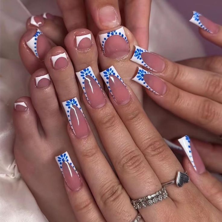 Chic Nail Design: Classic French Tips with Intricate Blue Patterns