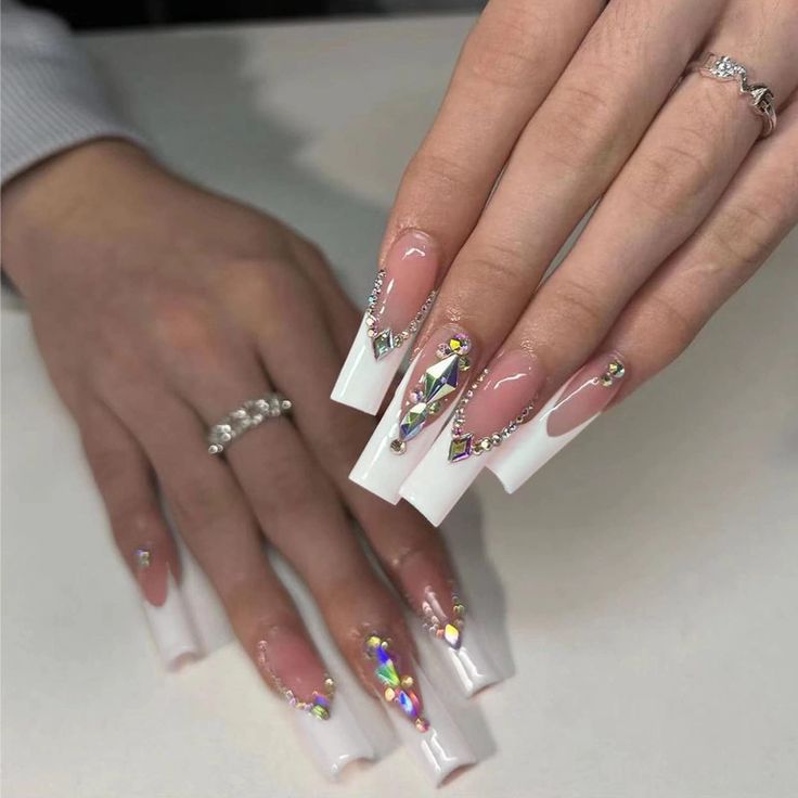 Sophisticated White and Clear Ombre Nail Design with Gem Accents and Geometric Embellishments