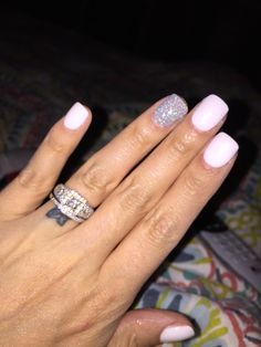 Chic Pastel Pink Nail Design with Glamorous Silver Glitter Accent.