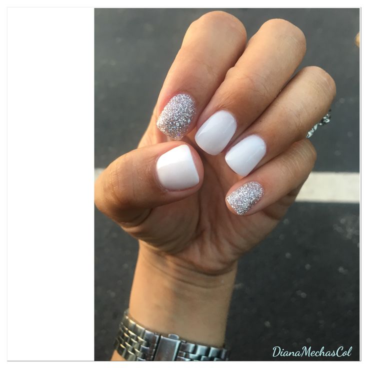 Elegant Nail Design: Glossy White and Sparkling Silver Accents with Matte Finish.