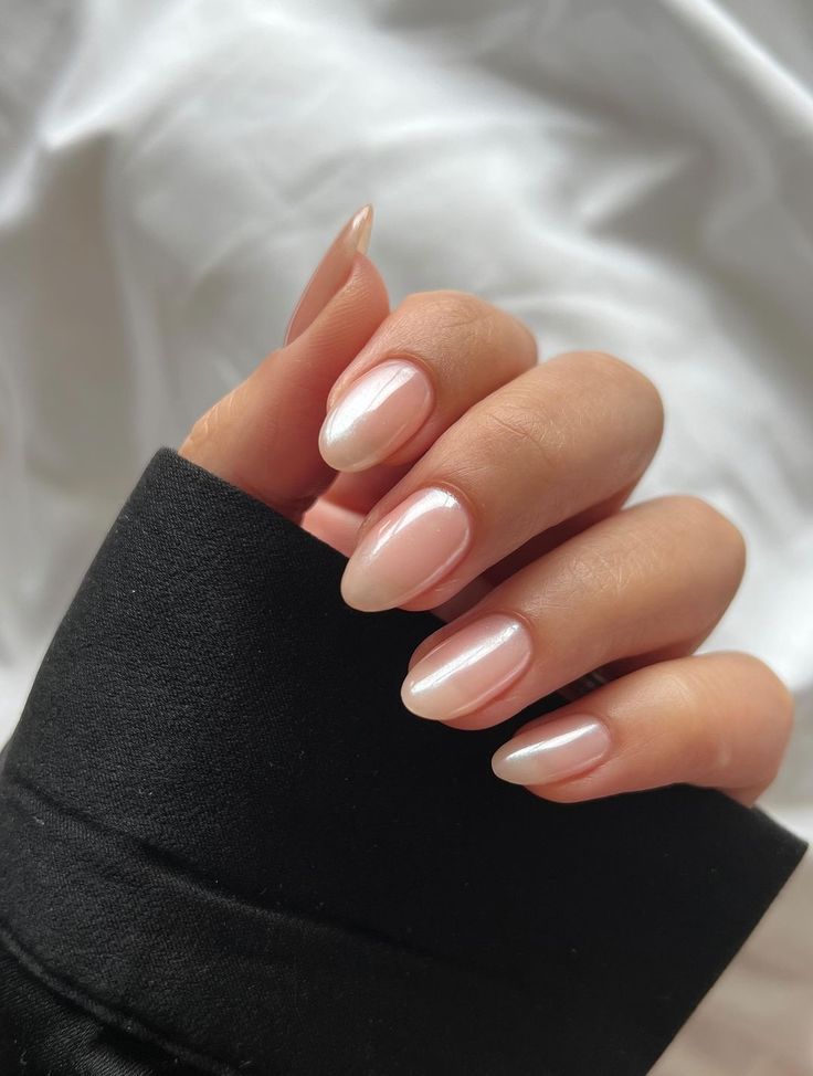 Sophisticated Almond-Shaped Ombre Nails: Sheer Pink to Subtle White with Glossy Finish.