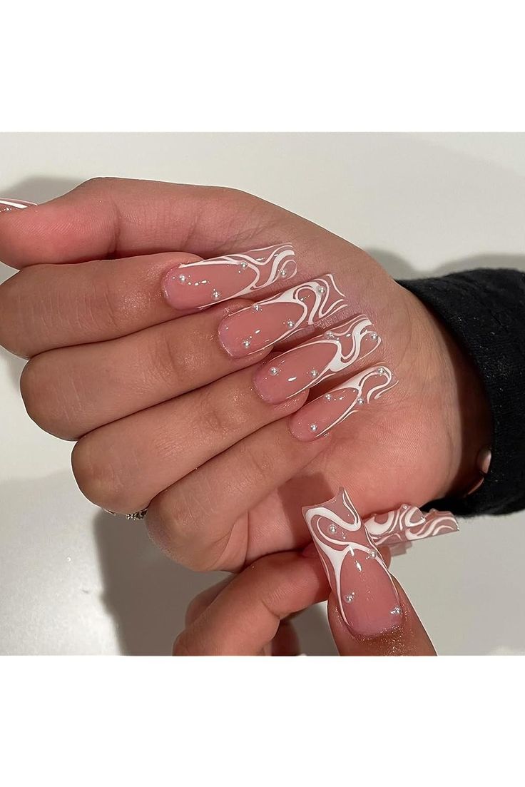 Contemporary Elegant Soft Pink Nail Design with White Swirls and Sparkling Accents