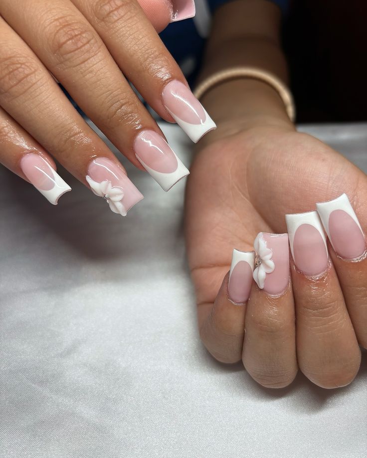 Chic Nail Design: Soft Pink and Striking White Tips with Floral Accents