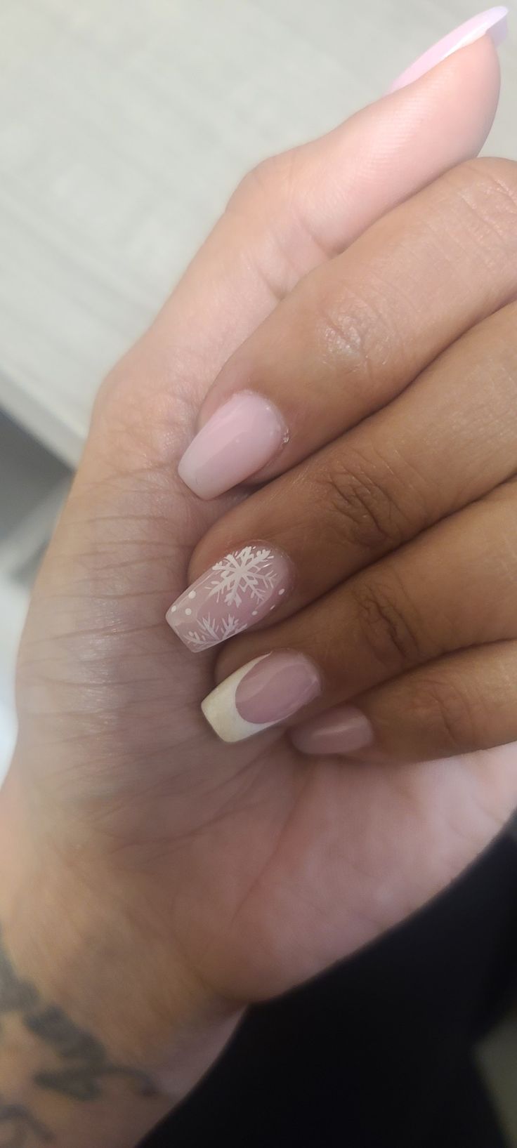 Elegant Winter-Inspired Nail Design with Soft Pink Base and Snowflake Motif