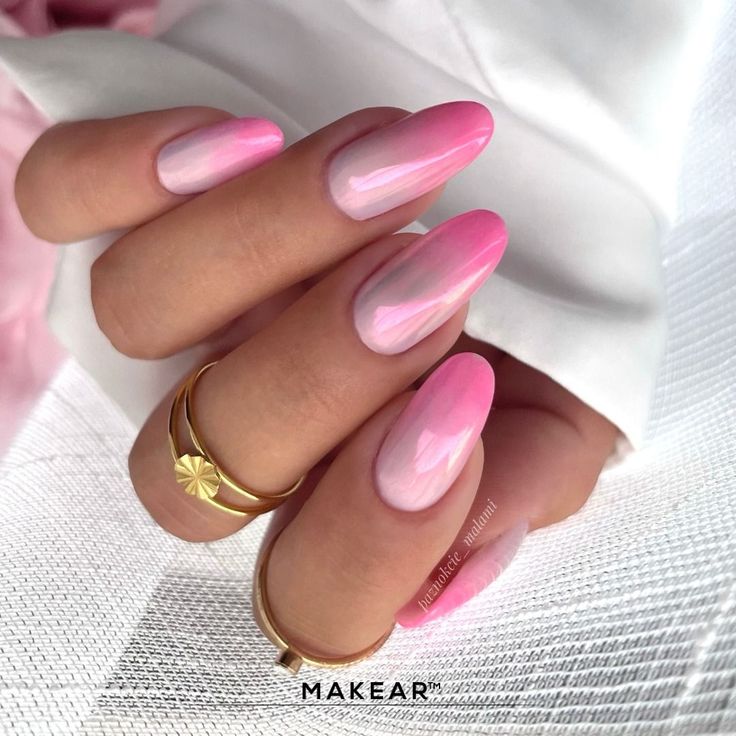 Elegant Ombre Nail Design in Soft Pink Hues with Glossy Finish and Gold Accents.