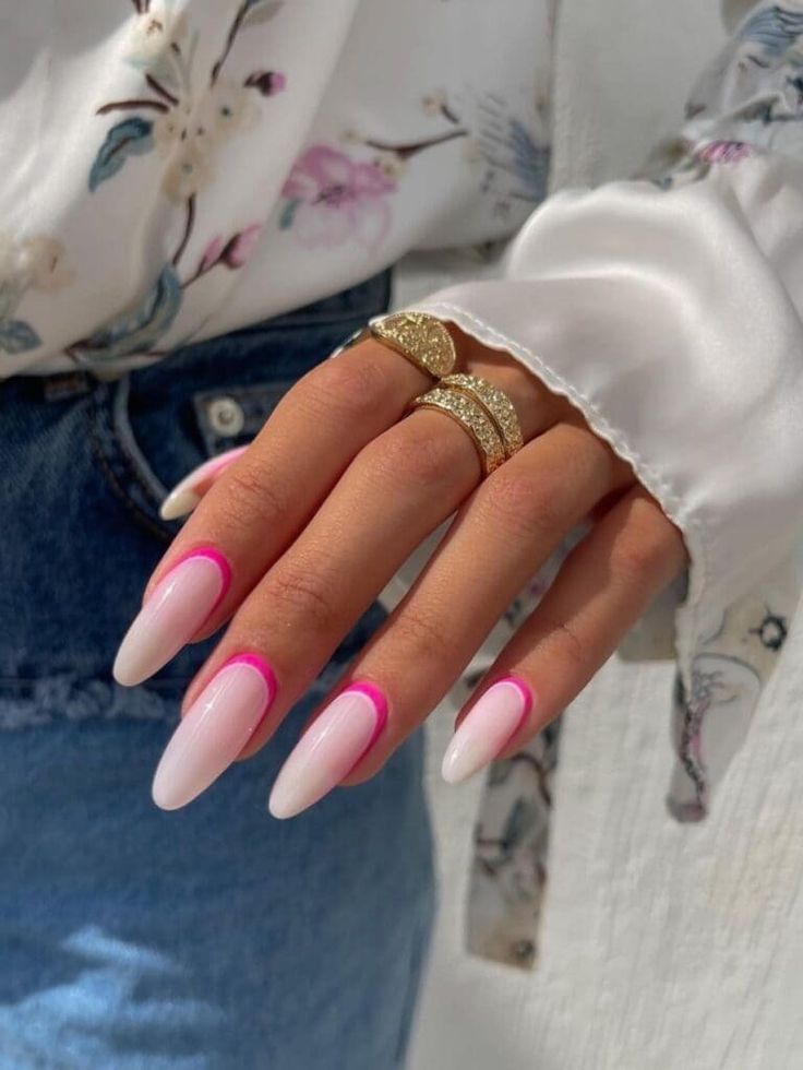 Chic Almond-Shaped Ombre Nails with Neon Pink Accents and Statement Rings.