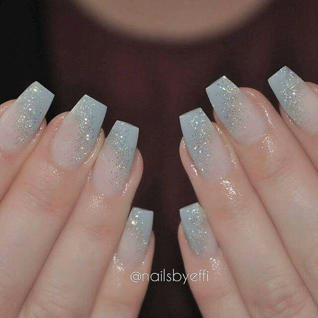 Ethereal Sparkling Ombre Nails: Translucent Base to Serene Pale Blue with Glitter Accents.