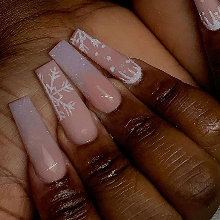 Sophisticated Ombre Nails with Snowflake Designs for a Festive Winter Look.