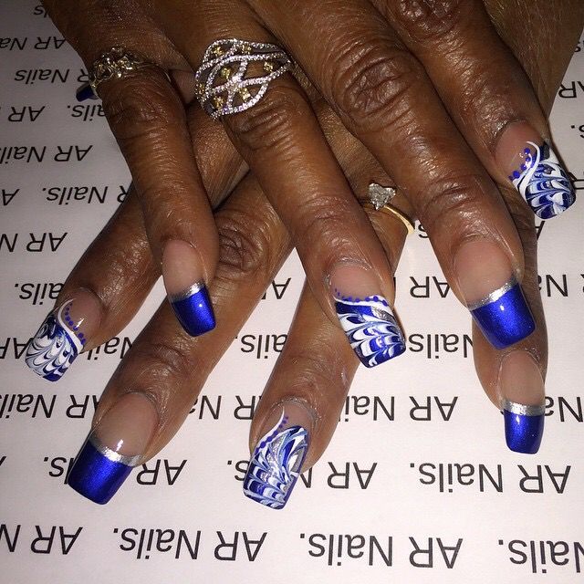 Elegant Blue and White Nail Design with Gradient Tips and Intricate Marbling.