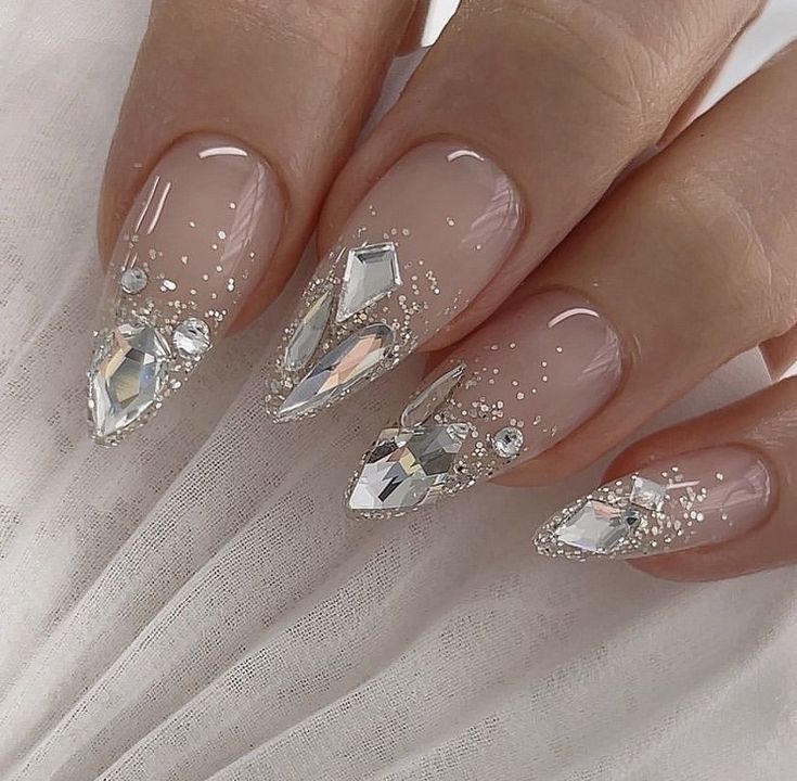 Sophisticated Elegant Nail Design with Nude Base, Rhinestones, and Glitter.