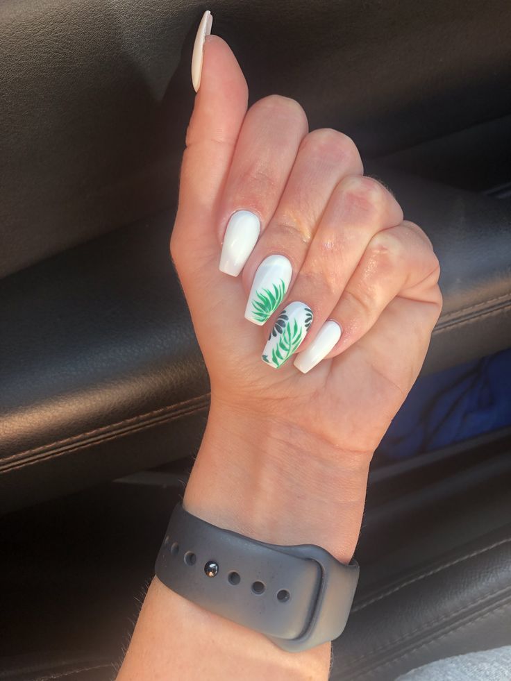 Chic White Nail Design with Green Leaf Accent and Elegant Watch.