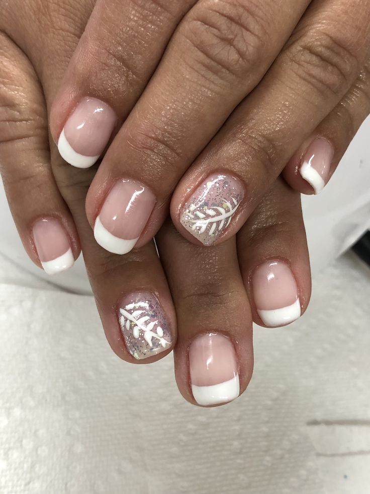 Elegant French Tip Nail Design with Glitter and Botanical Accents.