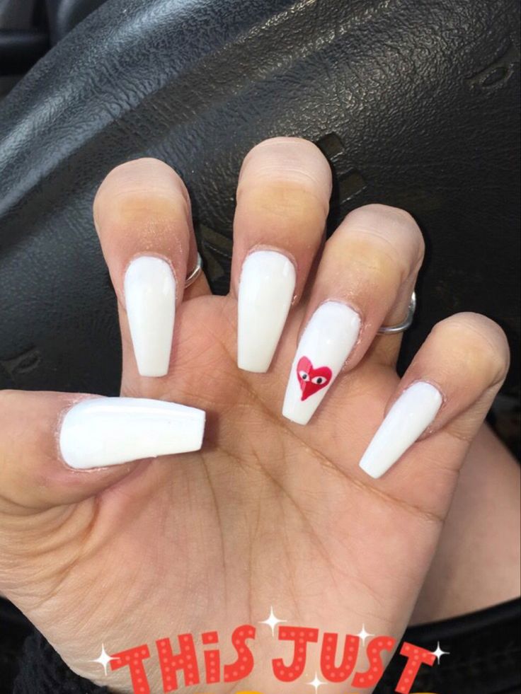 Chic White Nails with Bold Red Heart Accent for a Trendy Look.