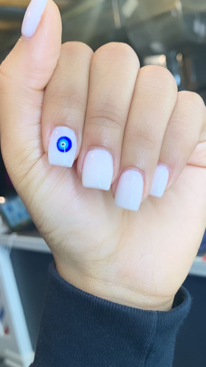 Chic Modern Nail Design with Cultural Blue and White Eye Symbol