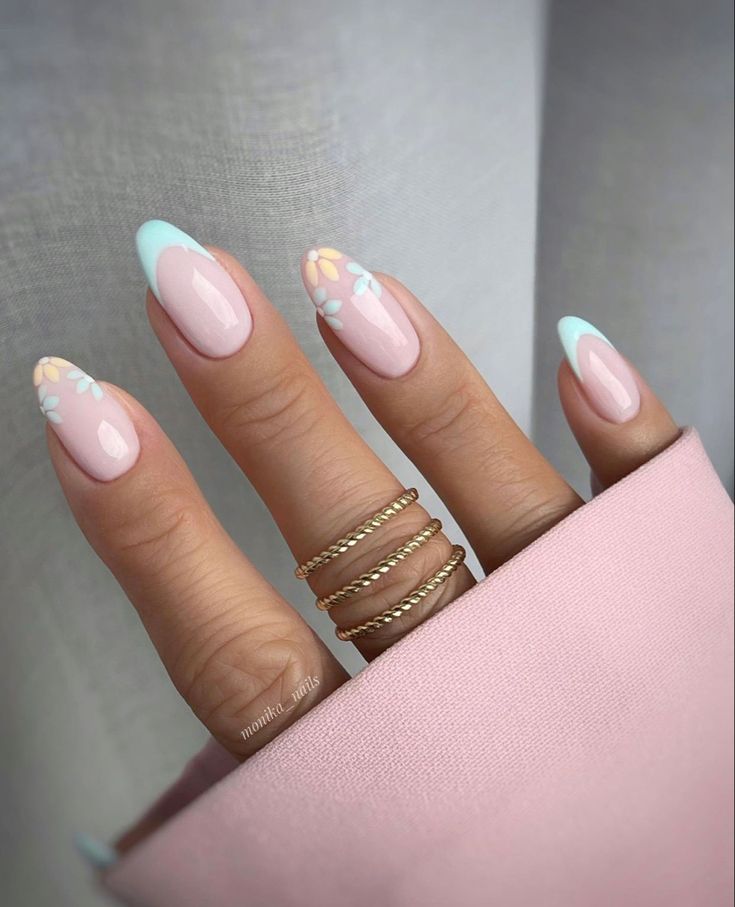 Chic Soft Pink and Mint Green Nail Design with Pastel Floral Accents and Gold Rings