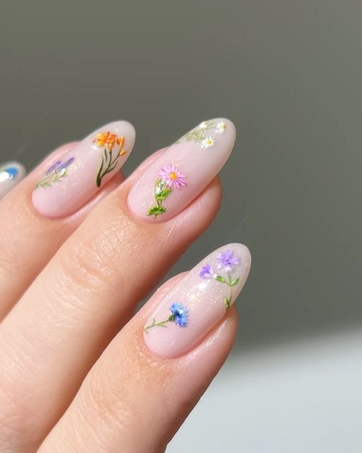 Charming Floral Nail Design with Pastel Patterns for a Fresh, Elegant Look.