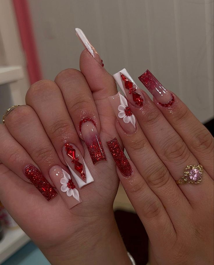 Vibrant Red Glitter and Floral Acrylic Nail Design with Glossy White Tips and Ribbons.